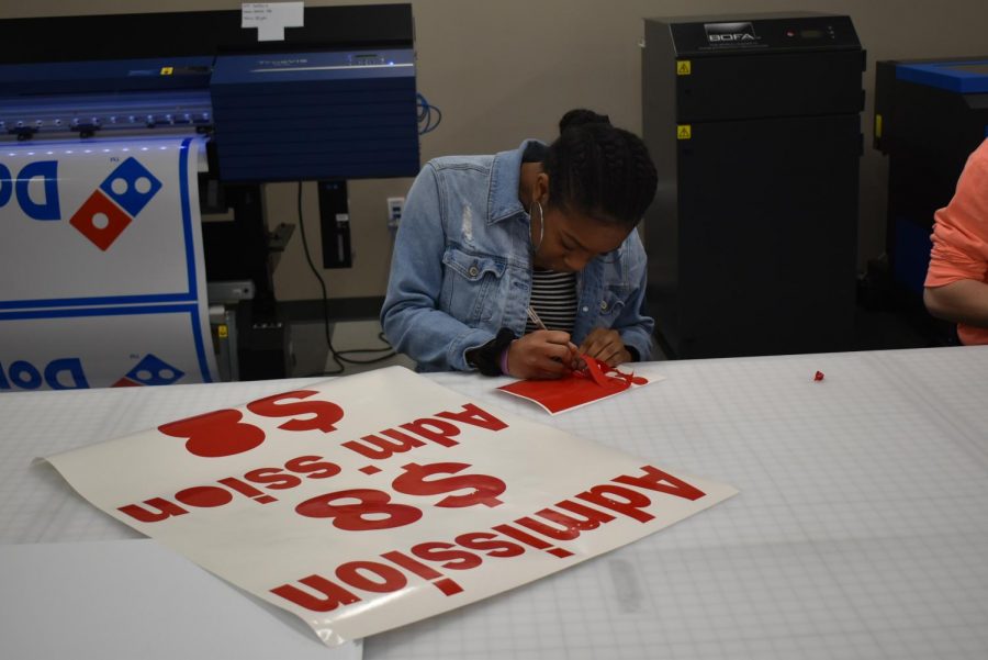 Students in the IT pathway help create signage used throughout the school and community. 