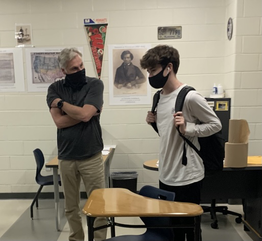 Teacher Todd Kornack and junior Jack Moeller have adapted to wearing masks during the school day.  COVID 19 protocols required mandatory masking in order to make in person learning possible. 