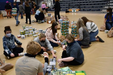 Students work to prepare their display of collected items before the annual canned food drive assembly at GCHS.  