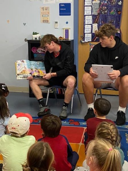Juniors Wyatt Hatch and Wyatt Seekford read to elementary students as part of the Warhawk Readers mentor program.
