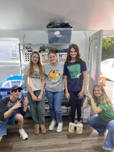 Jordan Thomson, Sydney Wilder, Anna Murphy, Abby Gordley, and Cat Hager volunteer to organize a clothing closet for The Gathering Place.  