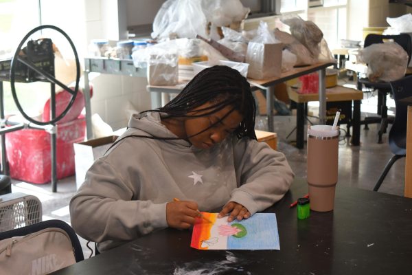 Jadah Jones works on a mixed media project during Art II.
